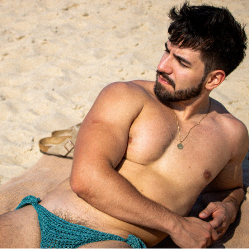 Man lying on the sand with a casual pose